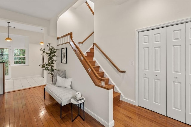 stairs featuring hardwood / wood-style floors and baseboards