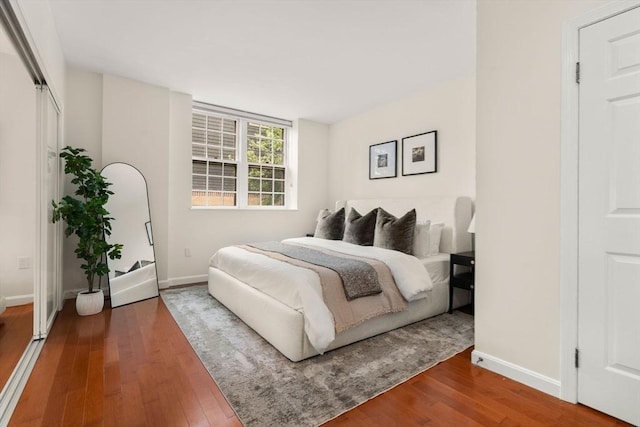 bedroom featuring baseboards and wood finished floors