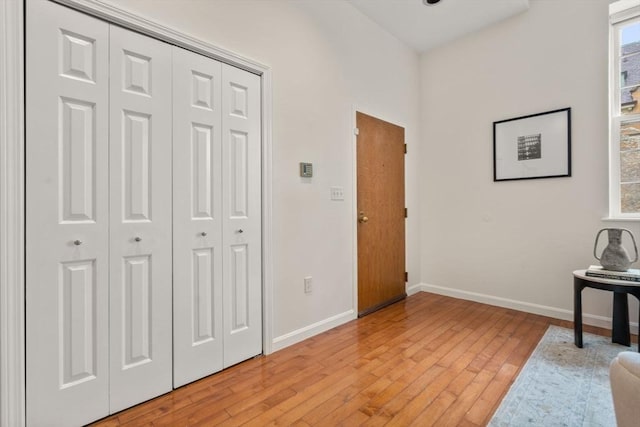 foyer entrance with baseboards and light wood-style floors