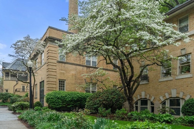 view of side of home with brick siding