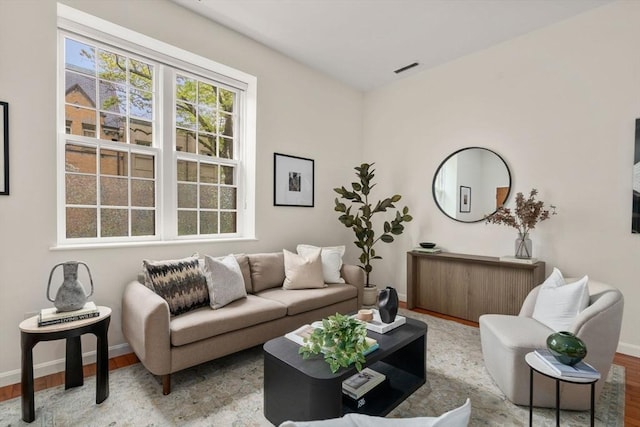 living area featuring baseboards and wood finished floors