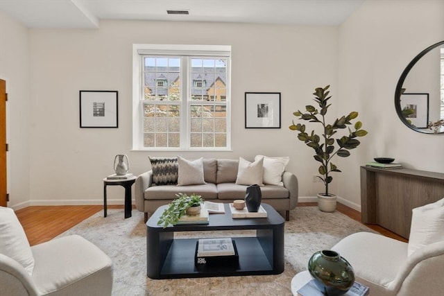 living area with wood finished floors and baseboards