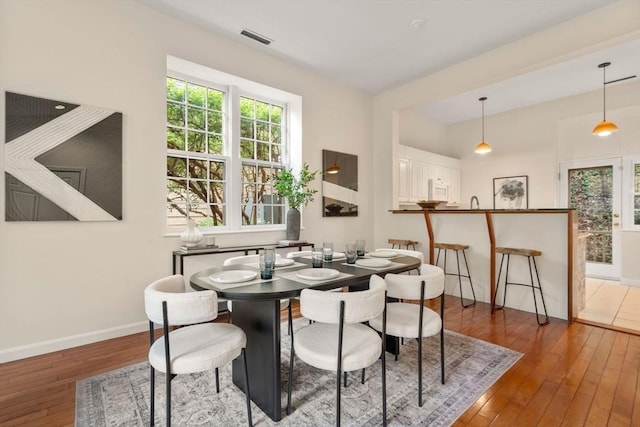 dining area with hardwood / wood-style floors and baseboards
