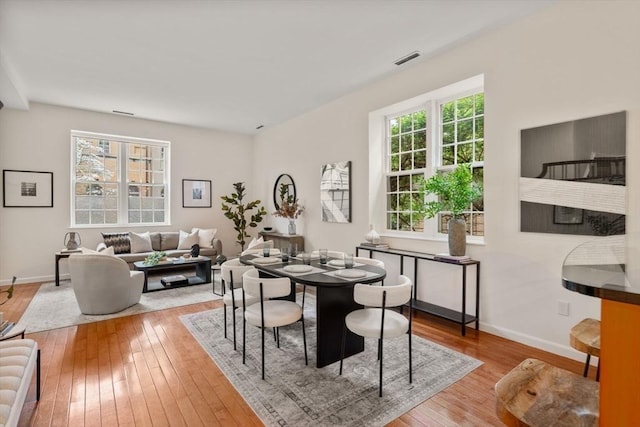 dining room featuring hardwood / wood-style flooring and baseboards
