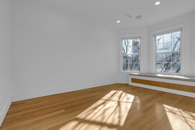 empty room with light hardwood / wood-style floors