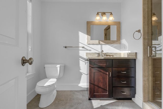 bathroom featuring vanity, toilet, an enclosed shower, and tile patterned flooring