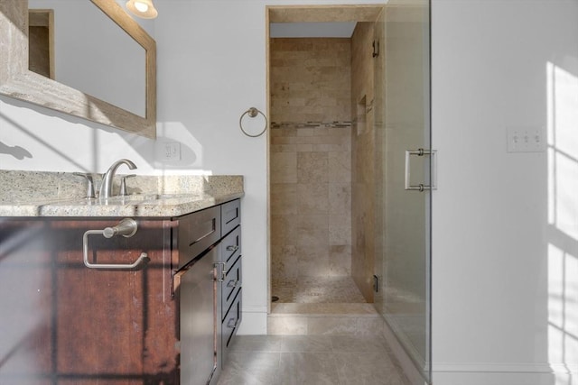 bathroom with walk in shower, tile patterned floors, and vanity