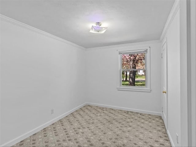 carpeted spare room with crown molding and baseboards