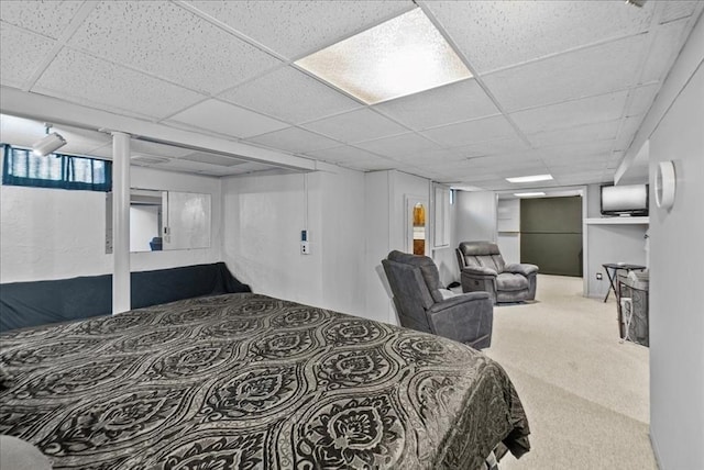 carpeted bedroom featuring a paneled ceiling
