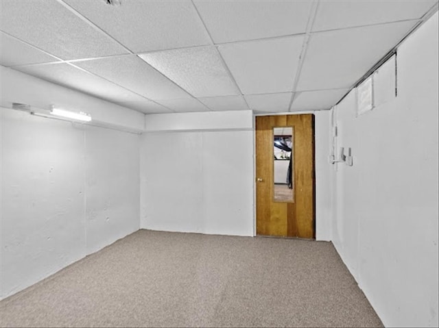 below grade area with carpet and a drop ceiling