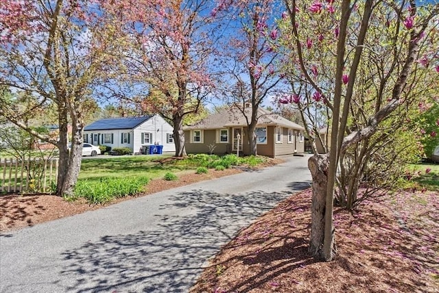 view of front facade with a front lawn and aphalt driveway