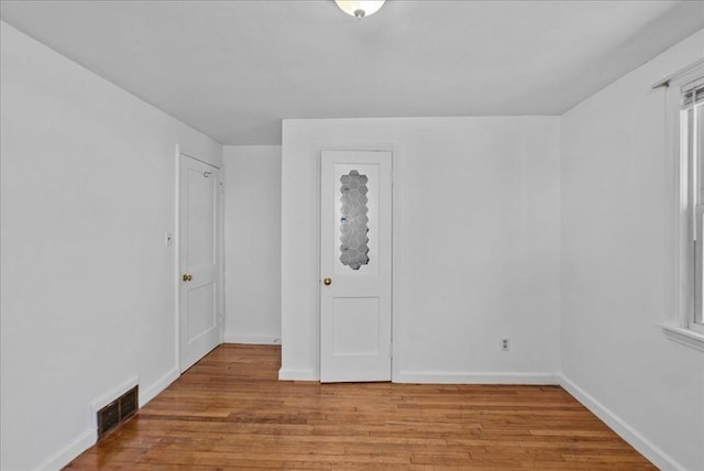 spare room with baseboards, visible vents, and light wood-style flooring