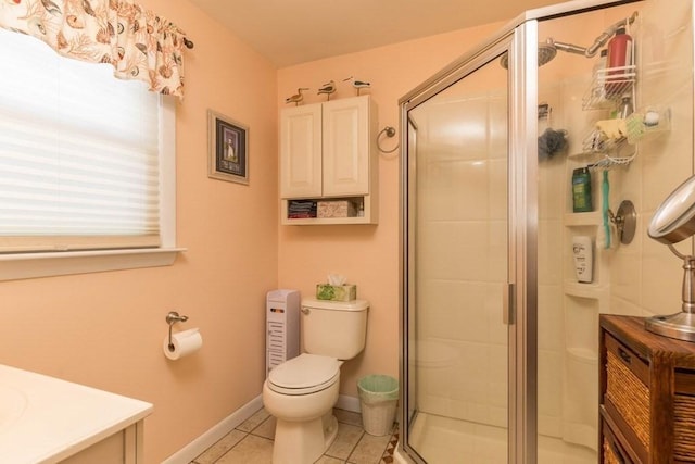 bathroom featuring walk in shower, vanity, toilet, and tile patterned flooring