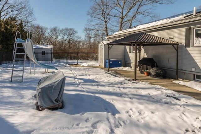 yard layered in snow with a gazebo