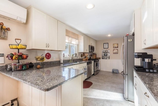 kitchen with dark stone countertops, a wall mounted AC, sink, and white cabinets