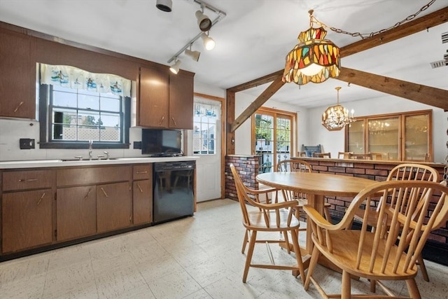 kitchen with light floors, light countertops, a chandelier, a sink, and dishwasher