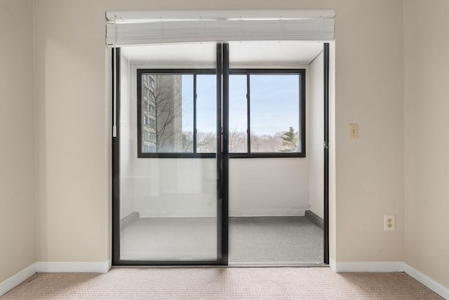 interior space with carpet flooring and baseboards