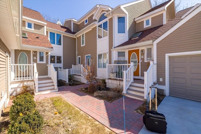 property entrance featuring a porch and a shingled roof