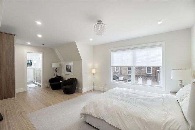 bedroom featuring recessed lighting, baseboards, connected bathroom, and wood finished floors