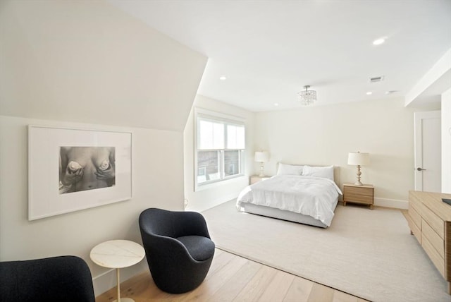 bedroom with recessed lighting, visible vents, baseboards, and wood finished floors