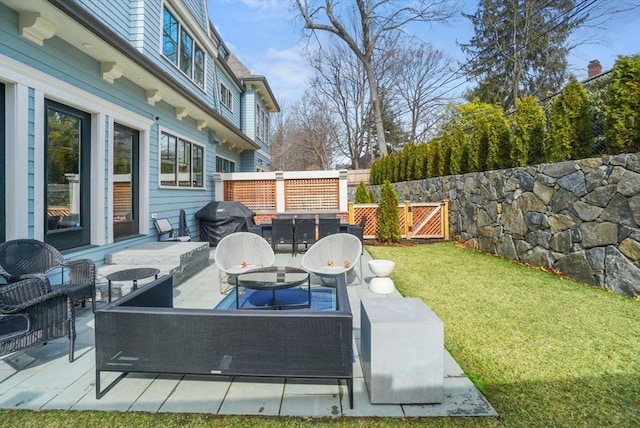 view of patio with an outdoor living space, a grill, and fence