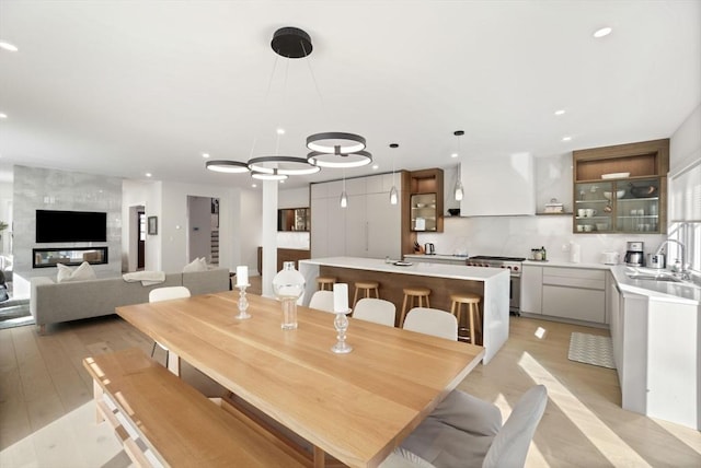 dining room with light wood-type flooring and recessed lighting