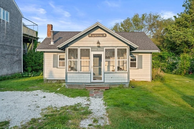 19 Borden, Scituate, MA 02066 - view of front of house with a shingled roof, a chimney, a front yard, and a sunroom
