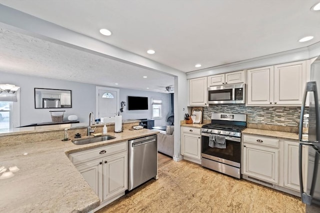 19 Borden, Scituate, MA 02066 - kitchen with appliances with stainless steel finishes, light stone counters, open floor plan, recessed lighting, and backsplash