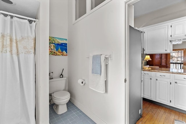 bathroom with tile patterned flooring and toilet