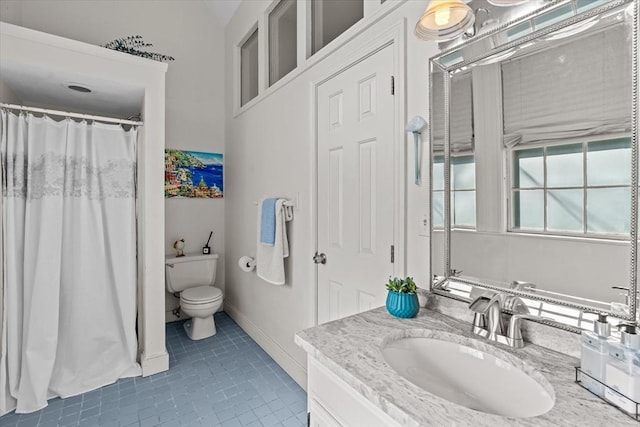 bathroom with vanity, toilet, and tile patterned flooring