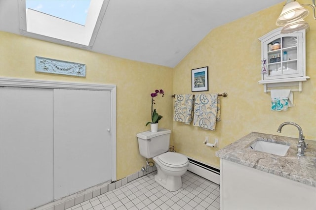 bathroom with tile patterned floors, lofted ceiling with skylight, toilet, baseboard heating, and vanity