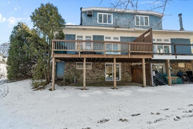 snow covered property featuring a wooden deck