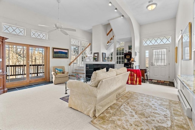 living room with ceiling fan, a healthy amount of sunlight, and carpet flooring