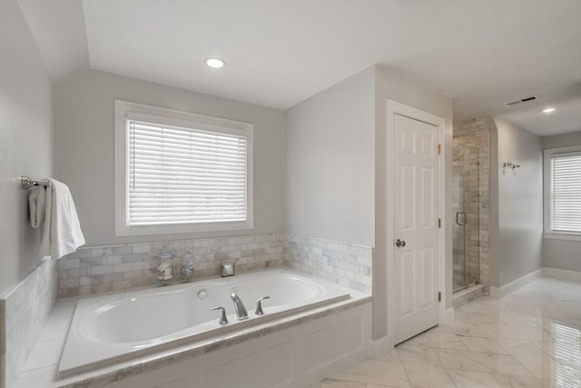 bathroom with a wealth of natural light and independent shower and bath