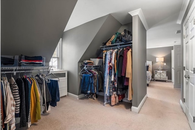 spacious closet with light carpet and lofted ceiling