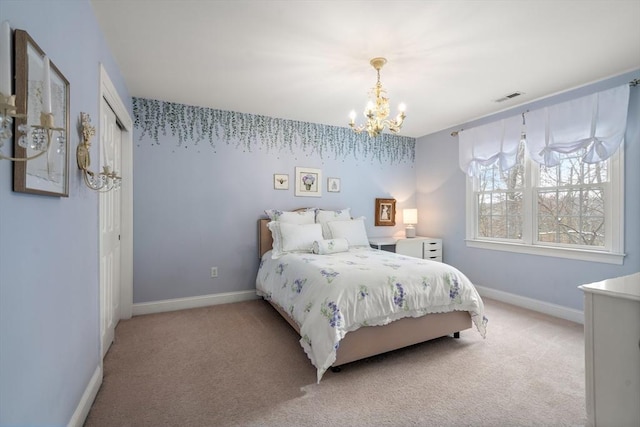 bedroom featuring light carpet and an inviting chandelier