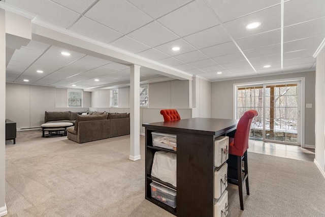 dining space featuring light carpet, a paneled ceiling, and a baseboard heating unit