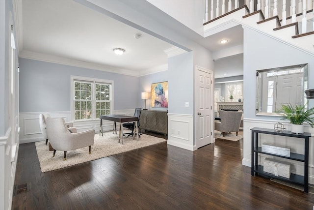 interior space with dark hardwood / wood-style flooring, ornamental molding, and a healthy amount of sunlight