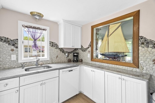 6 N Rd, Mattapoisett, MA 02739 - kitchen with dishwasher, white cabinetry, light wood-type flooring, light stone countertops, and backsplash