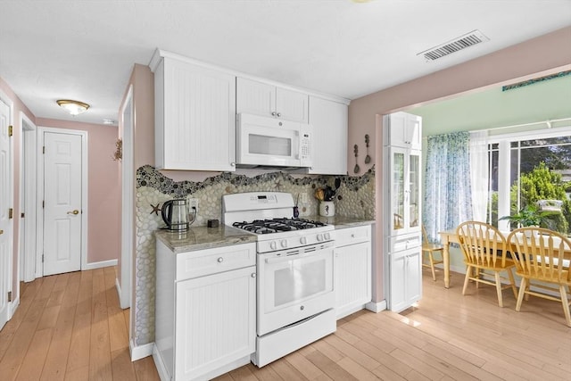 6 N Rd, Mattapoisett, MA 02739 - kitchen with white appliances, tasteful backsplash, light wood finished floors, white cabinetry, and light stone counters