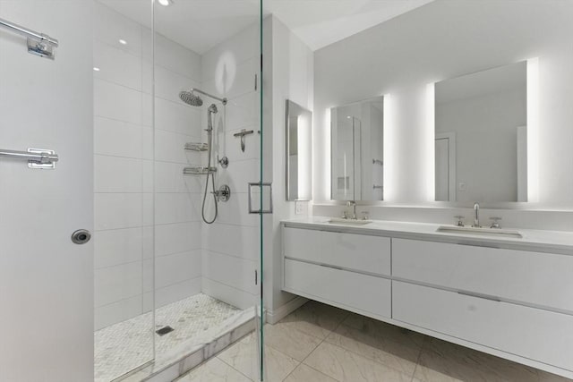 full bathroom with a stall shower, double vanity, and marble finish floors