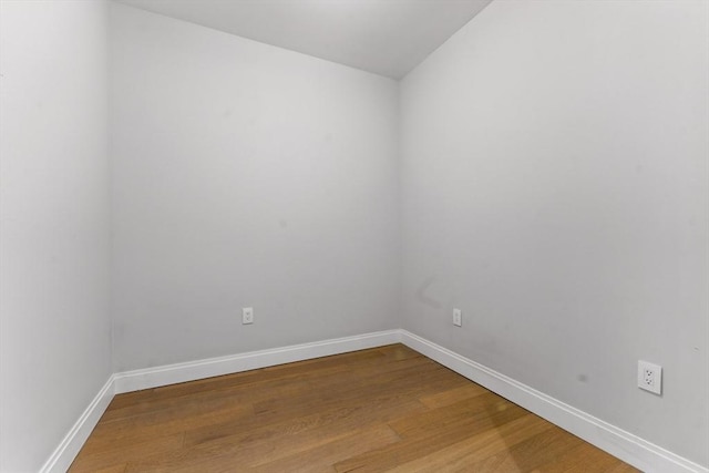 unfurnished room featuring wood finished floors and baseboards