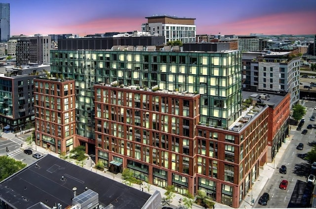 property at dusk featuring a view of city