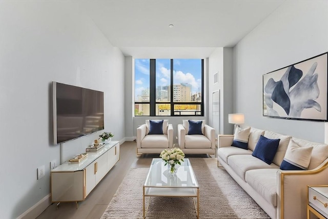 living area featuring light wood-type flooring and baseboards