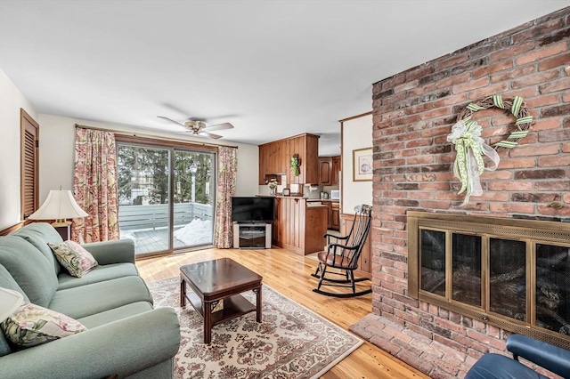 living area featuring ceiling fan and light wood-type flooring