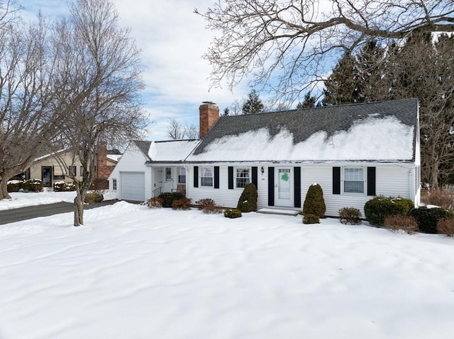 view of front facade with a chimney and an attached garage