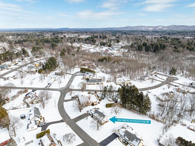 snowy aerial view with a mountain view