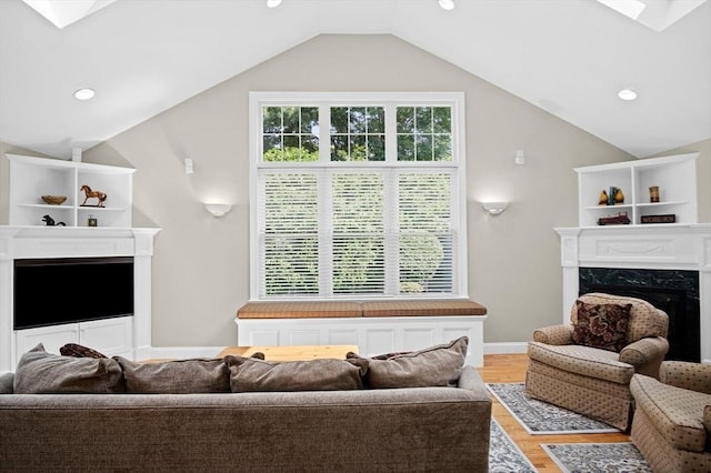 2 Christin Way, Woburn, MA 01801 - living room featuring a premium fireplace, a skylight, light wood-type flooring, lofted ceiling, and recessed lighting