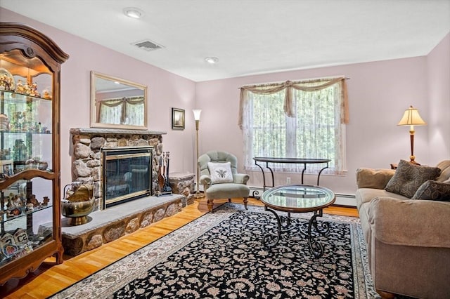 2 Christin Way, Woburn, MA 01801 - living area with wood finished floors, a stone fireplace, and a baseboard heating unit