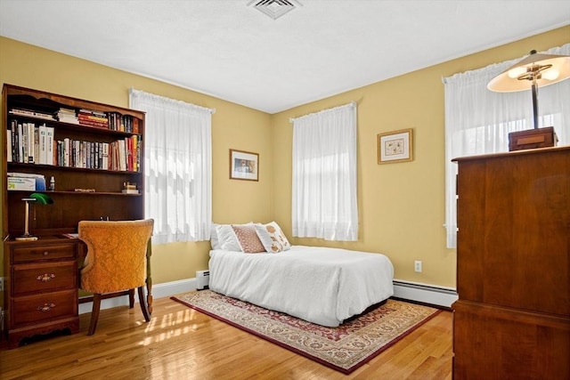 2 Christin Way, Woburn, MA 01801 - bedroom featuring baseboard heating, wood finished floors, and a baseboard heating unit